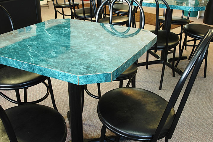 square laminate table with four black chairs